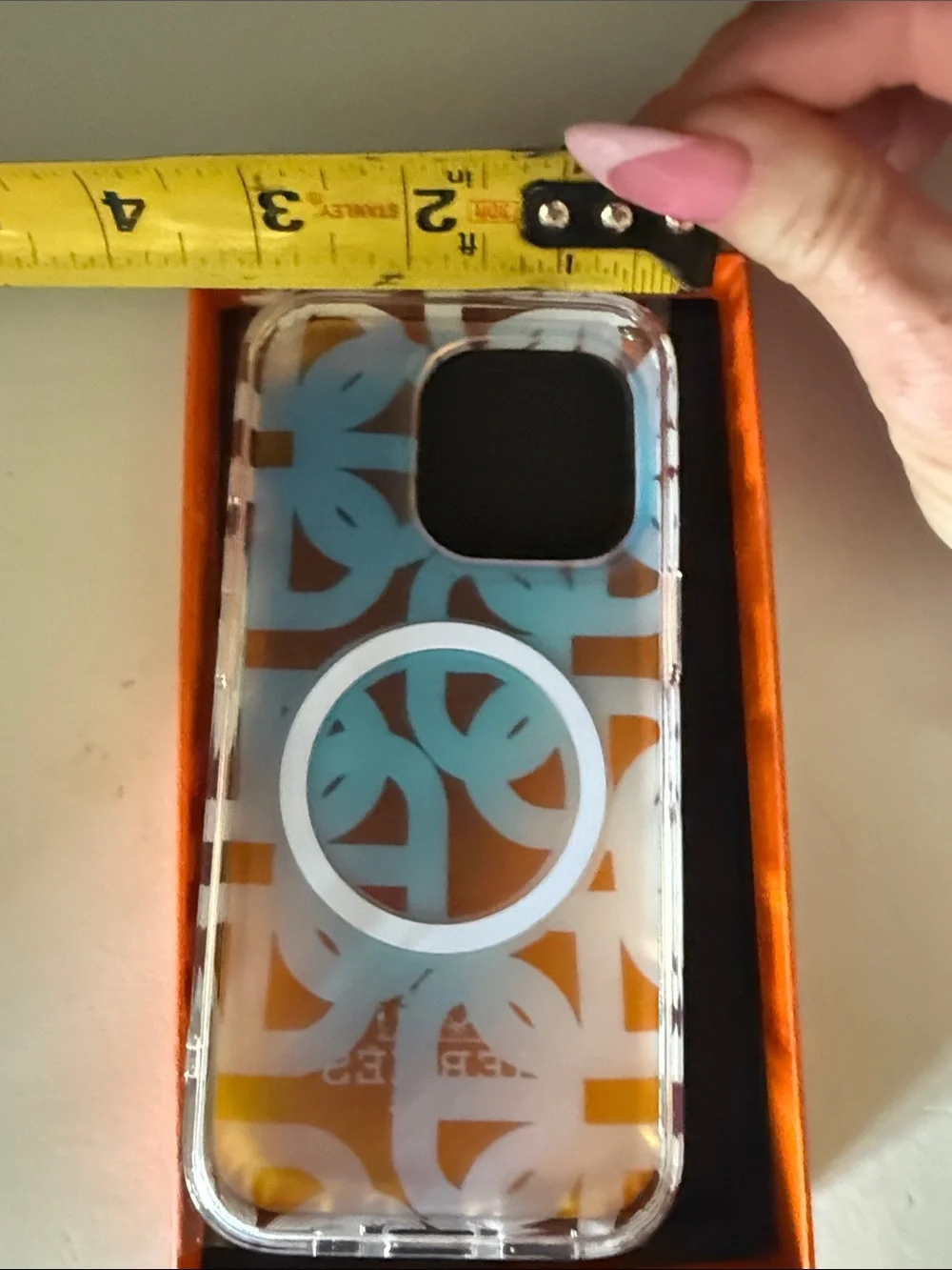 Hermes Orange & White Patterned Phone Case with Yellow Accent Charm